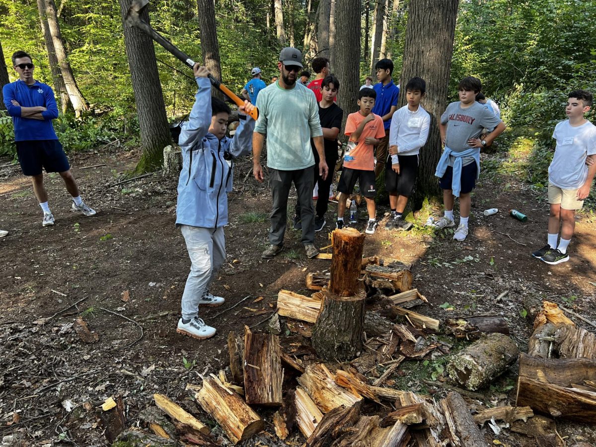 Mr. Lakey guided new Halsted students on the art of splitting wood during the cookout.